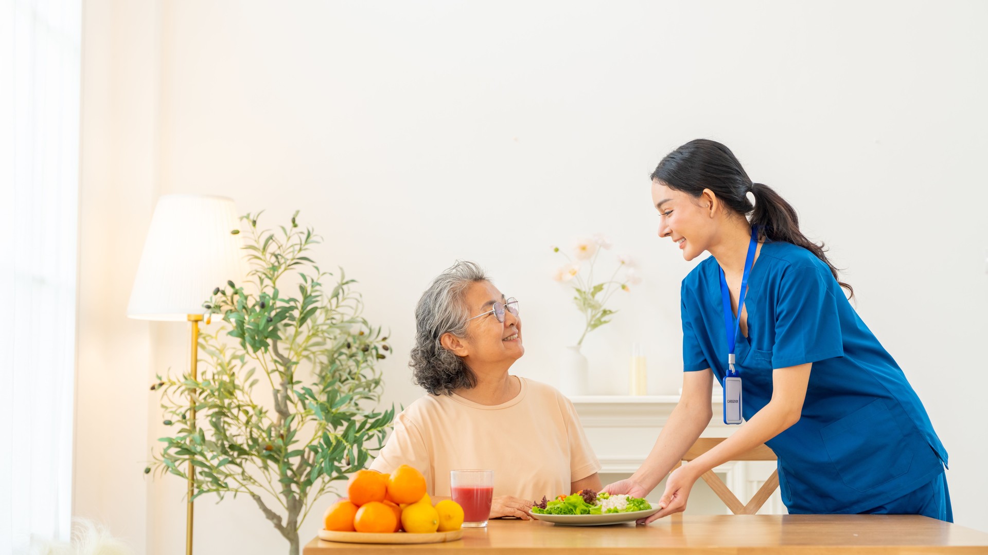 Asian senior woman eating healthy food at home.