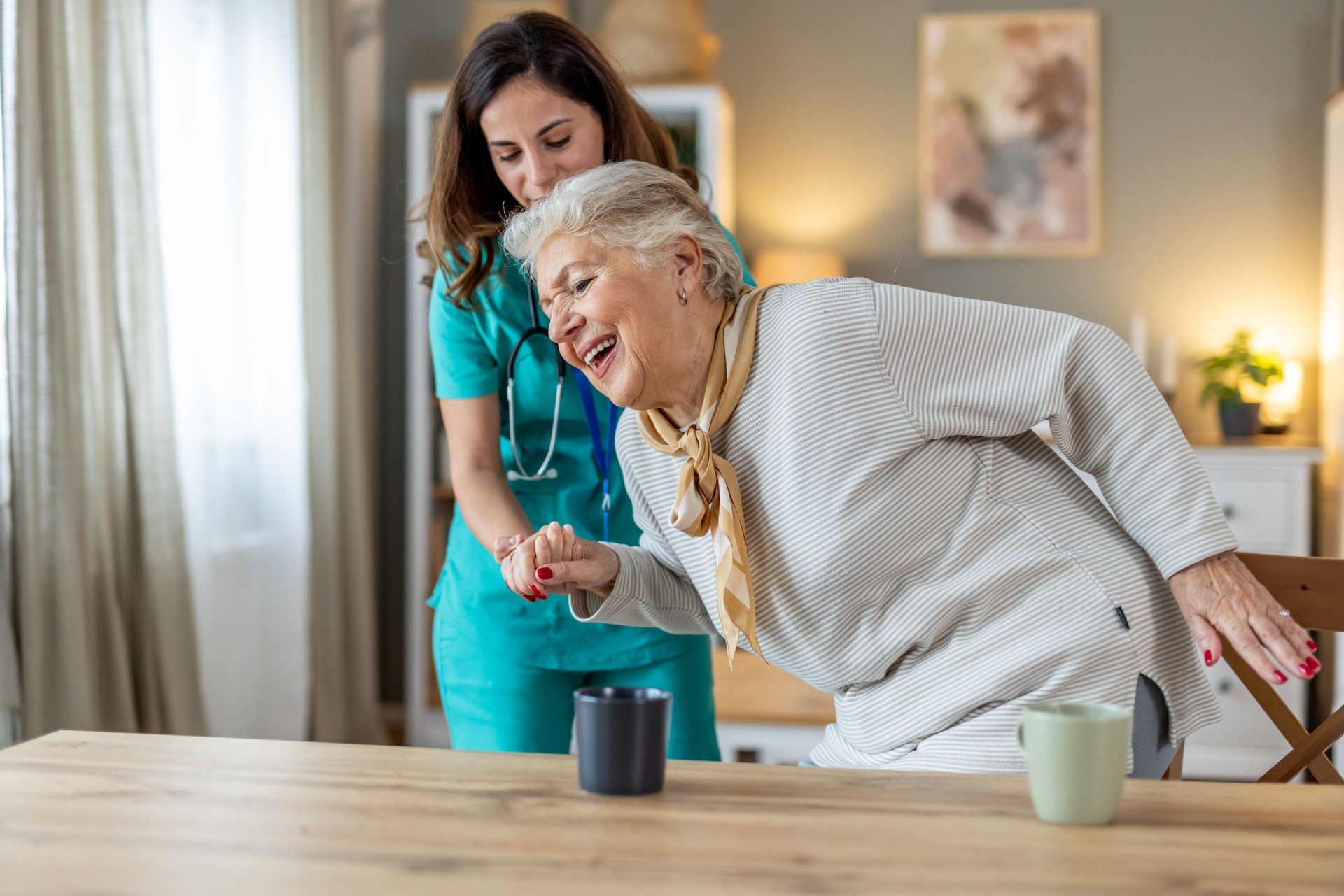 Elderly Woman Receiving Assistance from a Caregiver in a Comfortable Home Setting